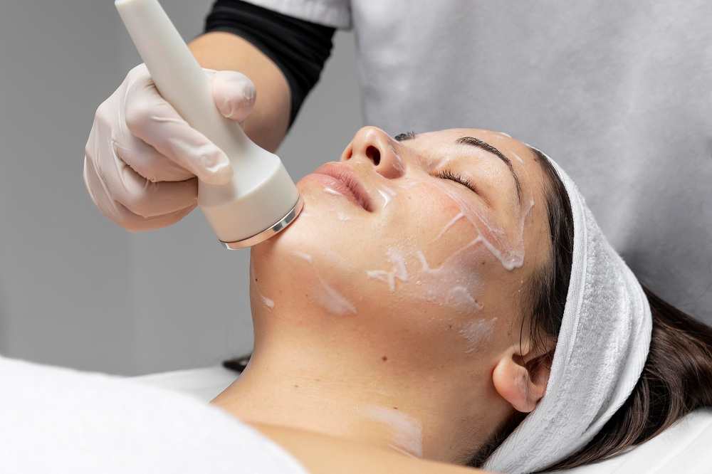 young woman having facial treatment compressed